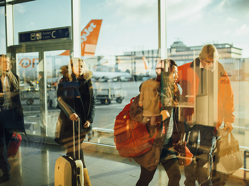 Group of people walking through an airport.