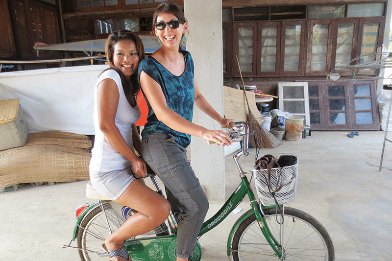 The writer sharing a bicycle with a friend in Chiang Mai, Thailand. 