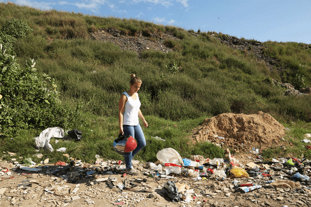 Mère et fille assises au milieu de déchets à Phnom Penh