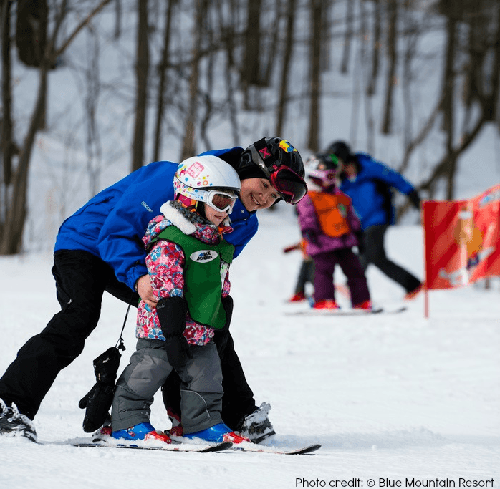 Mother and child playing in snow at Blue Mountain Village Resort, Ontario