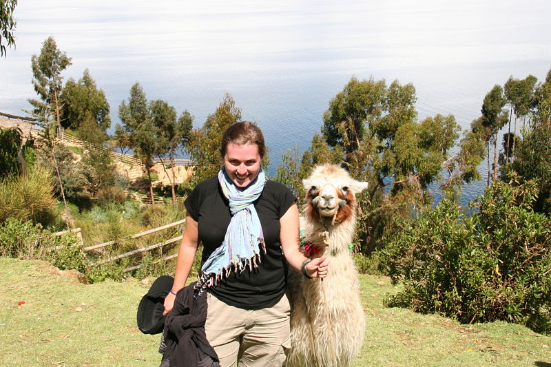 Girl Smiling beside Llama at Lake Titicaca Bolivia