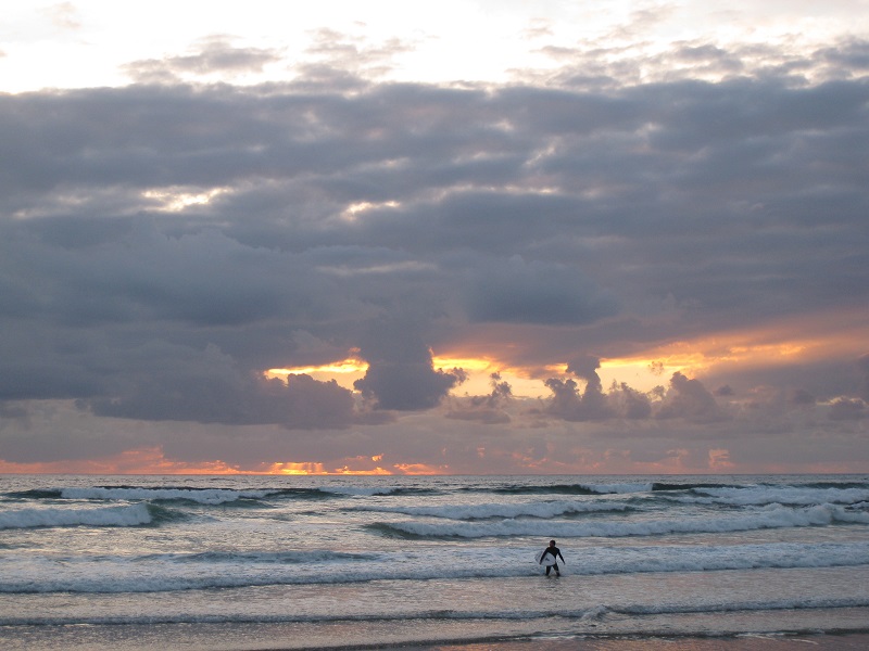 Lone surfer in Cornwall, England