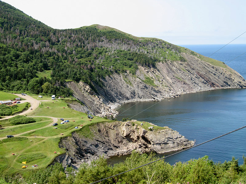 The view of the descent into Meat Cover reveals campers dotting the hillside.