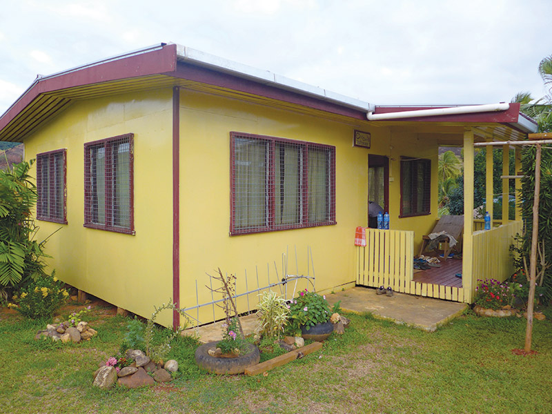 This is a photo of a yellow community center and storm shelter that was built in 2011.