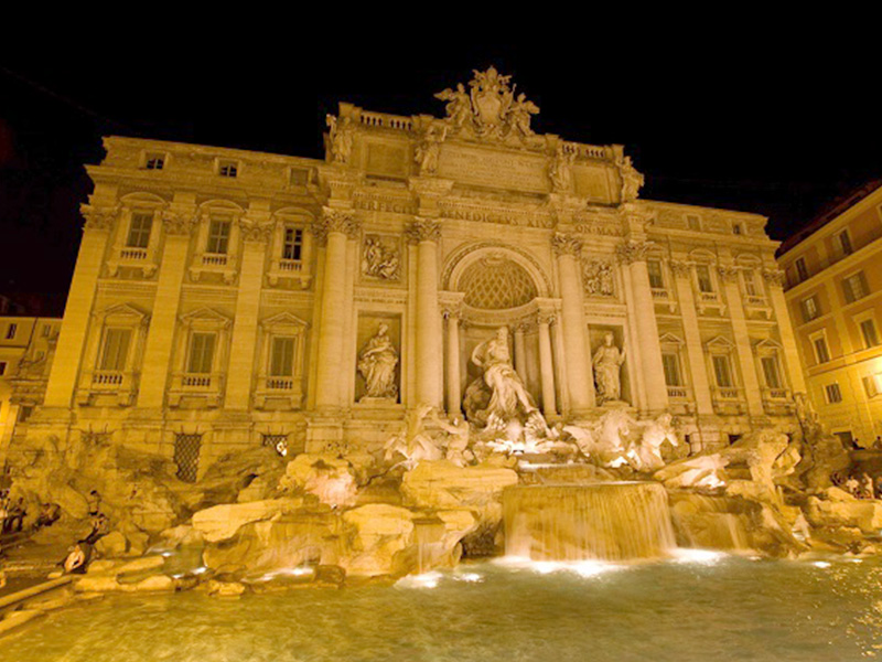 Make a wish and throw a coin in the Trevi Fountain in Rome 