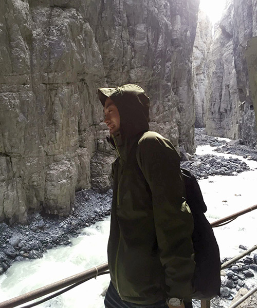 Traveller wrapped in warm clothes in the canyons of the glacier