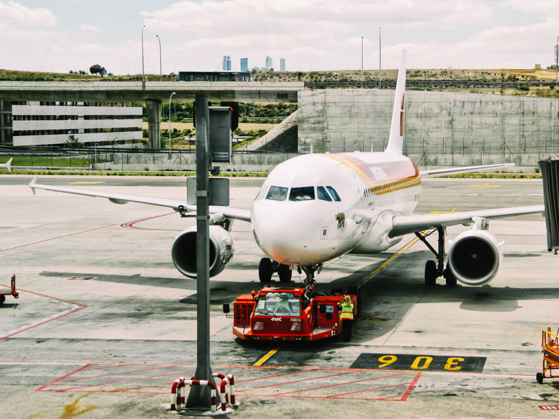 ): Airplane taxiing on an airport tarmac before departure for travellers’ vacations