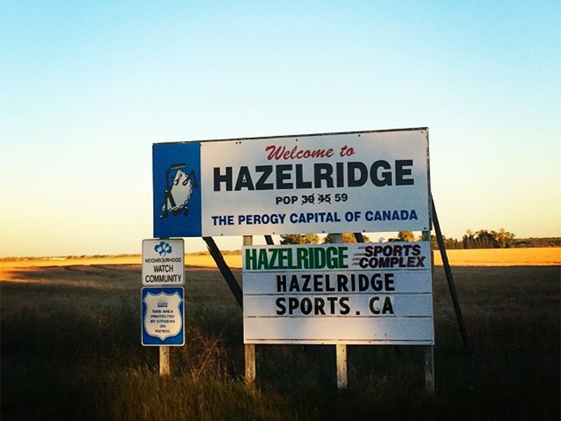 Road sign for Hazelridge, the perogy capital of Canada, on the side of a Manitoba highway