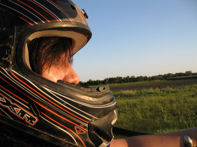 Photo of traveller riding a quad through fields, a top Manitoba attraction on any adventurer’s trip