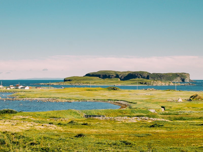 Photo of Newfoundland’s Anse aux Meadows along the Atlantic Ocean, a top destination for travellers