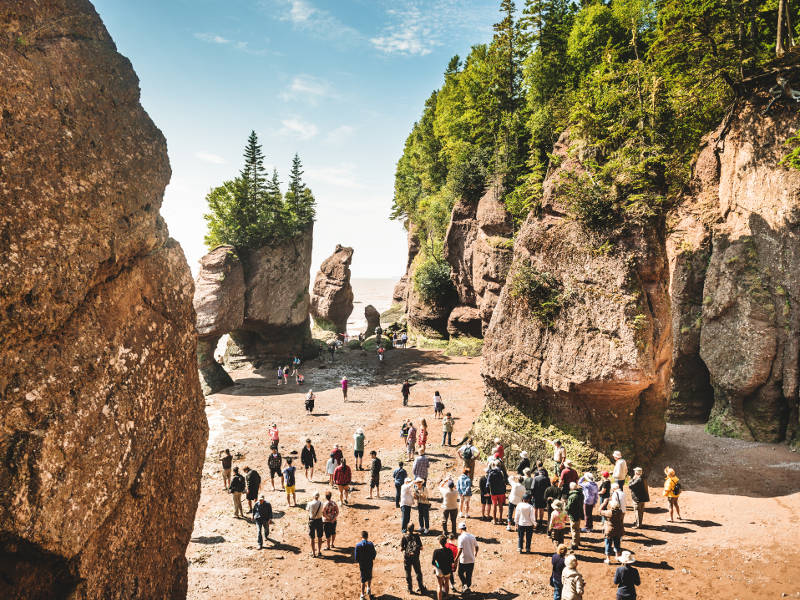 : Travellers visit the famous Hopewell Rocks during low tide, on the shores of the Bay of Fundy near Moncton, NB.