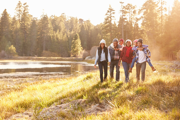 Extended Family Group Walking By Lake