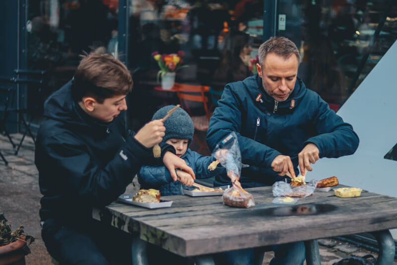 family enjoys meal outside