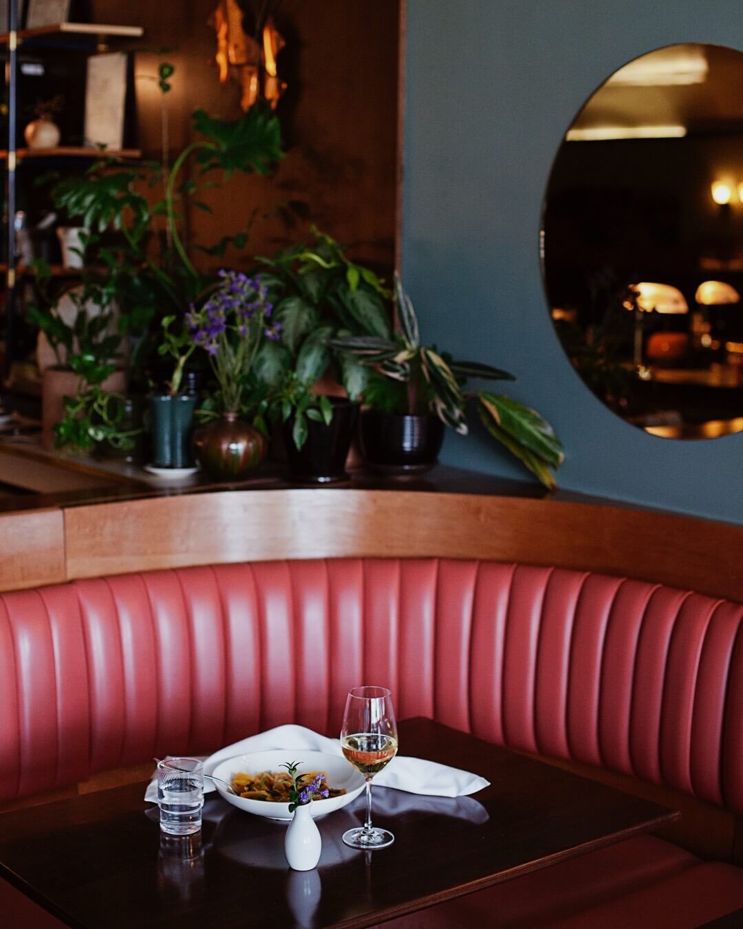 Set table with glass of wine and booth, Kissa Tanto, Vancouver, BC