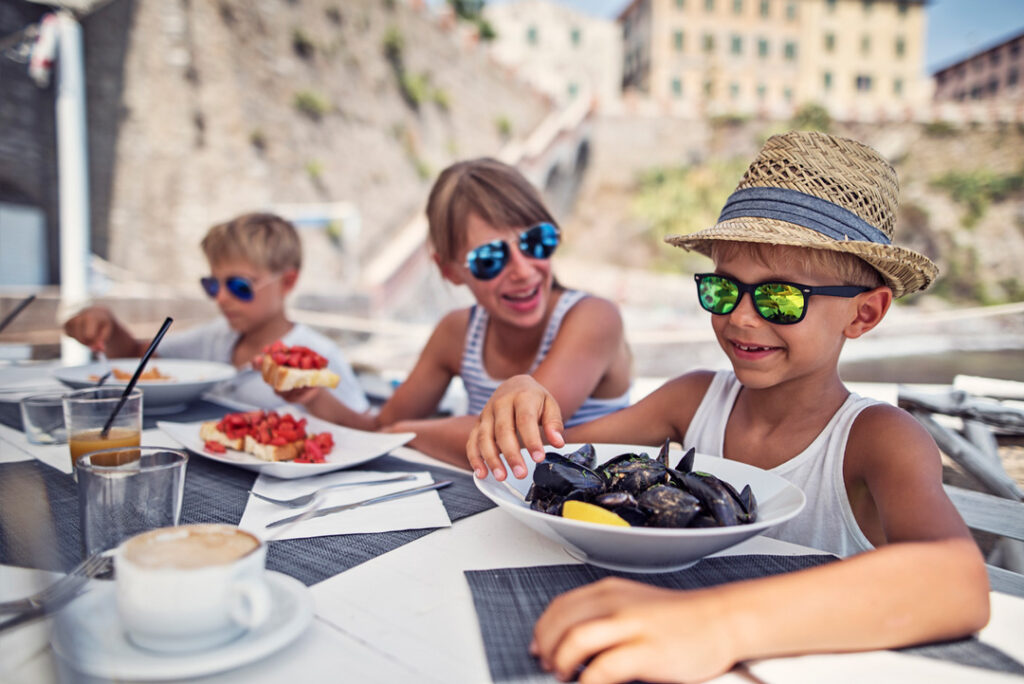 Family eating local food in Italy