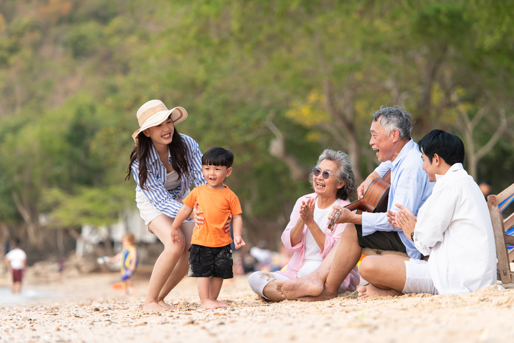Multi-generational Asian family on a beach